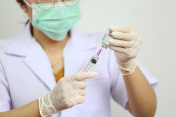 Doctor hand holding draw syringe and medicine bottle on white background, Medicine concept