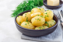 New Young Boiled  Potato Topped With Melted Butter And Chopped Dill In Ceramic Bowl, Horizontal, Copy Space