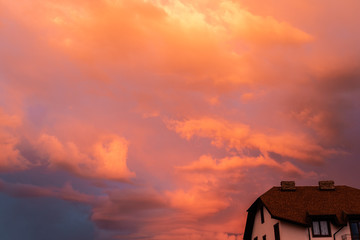 Wall Mural - Dramatic orange sky with clouds at sunset. It can be used as a background