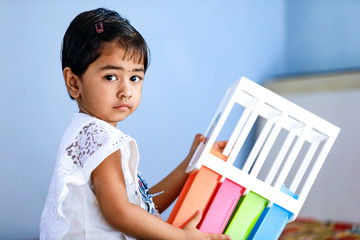 Wall Mural - young indian girl playing at home