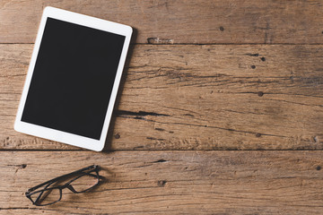 Wall Mural - Top view of Pen, notebook, glasses, tablet on wooden table and copy space