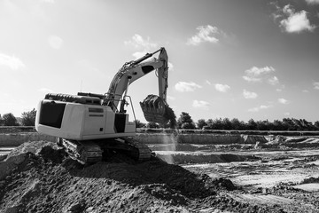 excavator picking up dirt on construction site