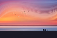 Fantasy Dreamy Landscape With Motion Blur Of Beach At Sunset With People