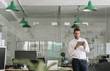 © mavoimages - Focused young businessman working on a tablet in an office