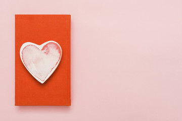 Top view of a book with a heart shape card