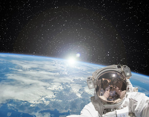 Wall Mural - astronaut makes selfie against sunrise. the elements of this image furnished by nasa.