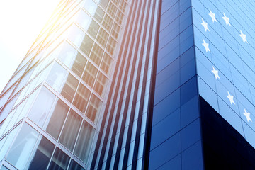 Modern office building with sign UE on a background of the blue sky