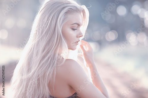 Cuadros en Lienzo blonde long hair nature summer / happy adult girl with developing in the wind lo