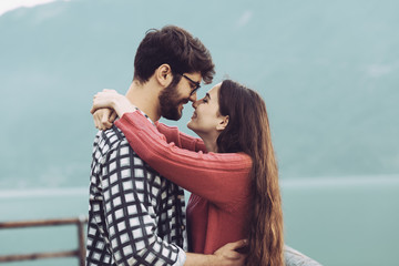 Wall Mural - Romantic couple hugging outdoors and smiling