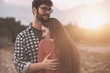© StockPhotoPro - Young loving couple hugging outdoors