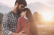 © StockPhotoPro - Young loving couple hugging outdoors