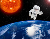 Fototapeta Kosmos - Big sun and astronaut flying in the space. The elements of this image furnished by NASA.