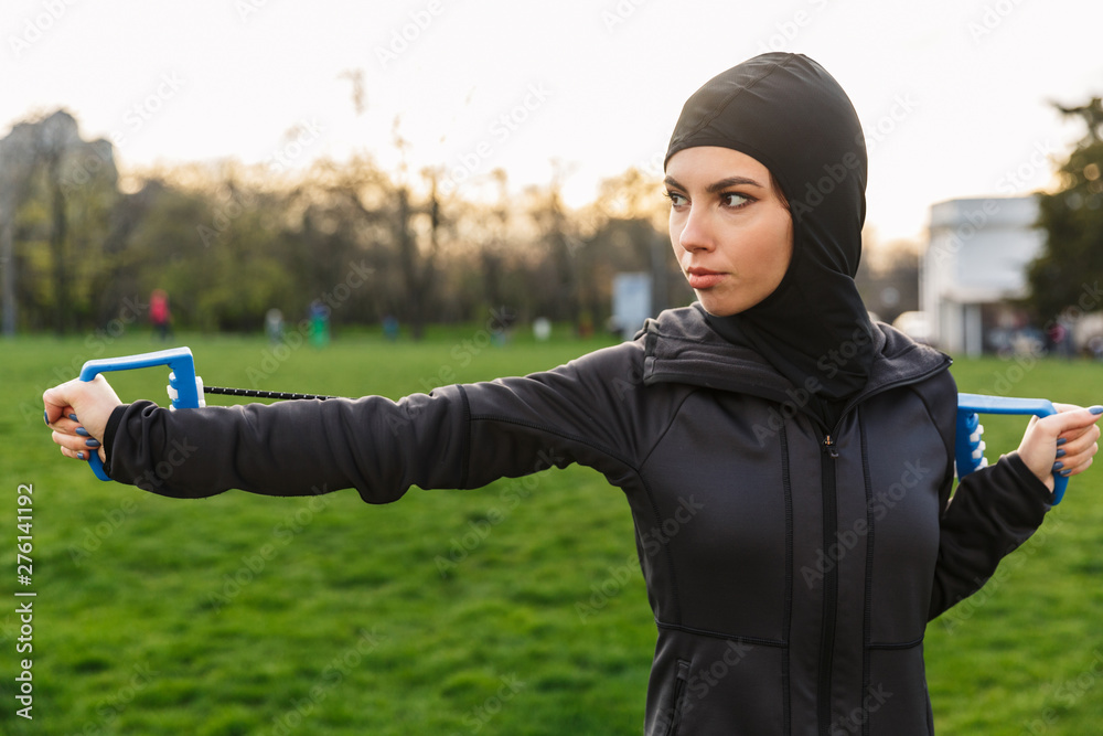 Young serious muslim sports fitness woman dressed in hijab and dark ...