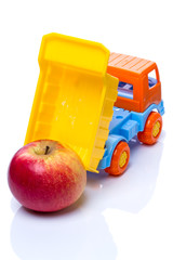 Wall Mural - Toy dump truck and apple