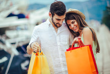 Couple On Summer Vacation Enjoying Travel And Shopping