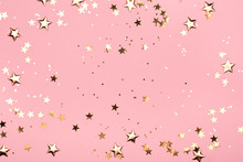 Golden Stars Glitter On Pink Background. Festive Holiday Pastel Backdrop.