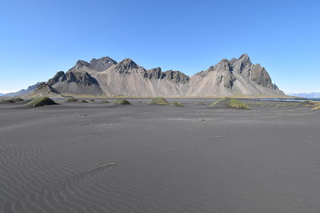 Wall Mural - Beautiful view of the Vestrahorn Mountains with black sand in front near Höfn in Iceland