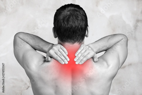Cuadros en Lienzo Strong man with neck pain, back view