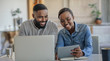 © mavoimages - Smiling African American couple working on their household finances together
