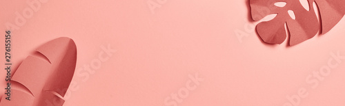 Cuadros en Lienzo panoramic shot of decorative paper cut exotic leaves on pink background with cop