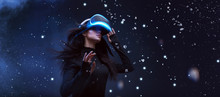 Beautiful Woman With Flowing Hair In Futuristic Dress Over Dark Background. Girl In Glasses Of Virtual Reality. Augmented Reality, Game, Future Technology Concept. VR.