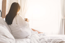 Asian Woman Relaxing In The Hotel Room, Drinking Morning Coffee, Copy Space