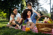 © NDABCREATIVITY - Happy male and female playing and enjoying picnic with children outside