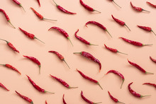 Flat Lay Dried Red Chili Peppers Pattern On A Pink Peach Color Background. Top View, Flat Lay.