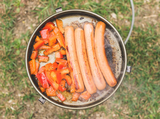 Sausages grilling in frying pan