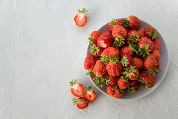 homemade ripe fresh sweet strawberry berries on a plate on a light concrete background. Healthy, tasty, organic food. Vitamin and fruit concept. Copy space. the view from the top