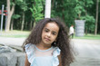 © bisonov - Beautiful Young Girl With Long Curly balck Hair in the park