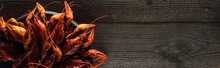 Panoramic Shot Of Red Lobsters On Plate At Wooden Surface