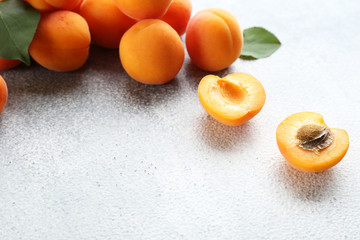 Bunch of ripe organic apricots in pile on grunged concrete textured table. Local produce harvest heap. Clean eating concept. Background, top view, close up, copy space, flat lay.