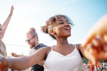 Multiethnic group of people having fun at summer music festival