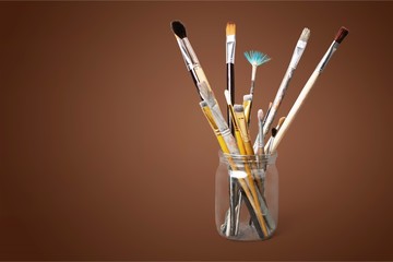 Wall Mural - Brushes in glass jar isolated on white