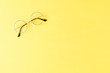 © One Pixel Studio - Fashion eyeglasses on yellow background. Top view
