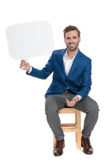 Poster - Positive casual guy holding a blank speech bubble