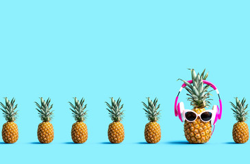 one out unique pineapple wearing headphones on a solid color background