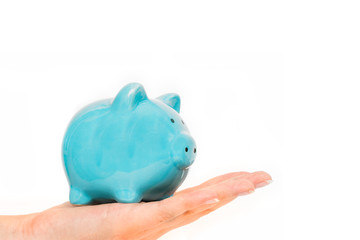 Piggy bank in female hand isolated on white background. Savings