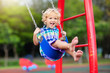 canvas print picture - Child on playground. swing Kids play outdoor.