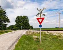 Rural Railroad Crossing In The Country Side With No Warning Devices Such As Lights Or Arms, Only A Yield Sign