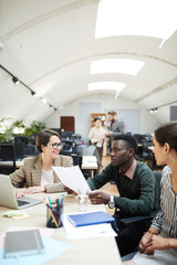 Wall Mural - Multi-ethnic group of people discussing work while collaborating in office, copy space