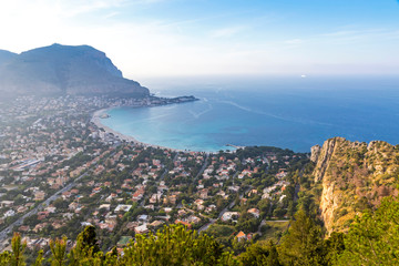 Panoramic aerial evening view of Mondello beach (Spiaggia di Mondello) in Palermo, Sicily, Italy. Beach lies between two cliffs called Mount Gallo and Mount Pellegrino. View from Mount Pellegrino