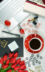 Canvas Print - Modern stylish feminine desk or workspace coffee break with high tech touchscreen laptop and red female accessories.