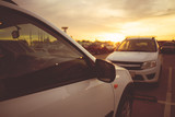 Fototapeta Sawanna - amazing sunset on the car parking in the city, selective focus