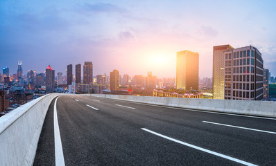 Shanghai skyline panoramic view with asphalt highway at sunset