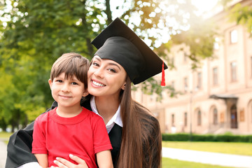 Wall Mural - Woman with little son on her graduation day