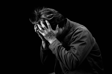 Wall Mural - Man sad cry or strain alone on black background black & white color