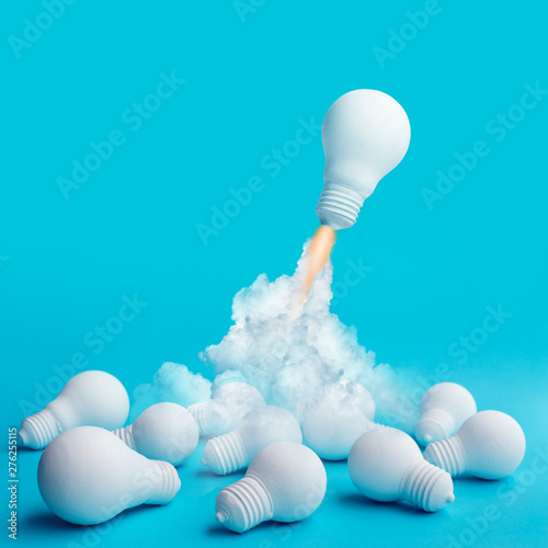 Fotomural Ideas inspiration concepts with rocket lightbulb flying on group of another ligh