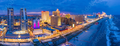 Aerial panorama of Atlantic city along the boardwalk at dusk. In the 1980s, A...